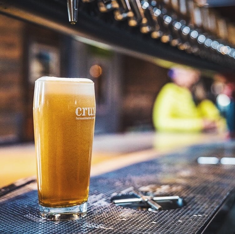 Pint poured from custom draft beer tower Easybar installed at Crux brewery