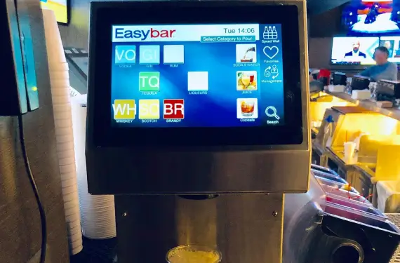 Easybar liquor gun system touchscreen interface displaying spirit categories including vodka, gin, tequila, whiskey, and cocktails at a commercial bar